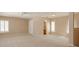 Expansive living room with neutral carpeting, bright windows, and a view of the bathroom at 2072 Hartz Aly, Orlando, FL 32814