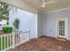 Charming covered porch features brick flooring and an access door to the home's exterior at 2072 Hartz Aly, Orlando, FL 32814