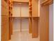 Spacious walk-in closet with custom wood shelving and ample storage space for clothes and accessories at 2072 Hartz Aly, Orlando, FL 32814