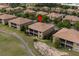 Aerial view of a brown-roofed home in a community with lush green landscaping at 8930 Azalea Sands Ln, Davenport, FL 33896