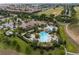 Aerial view of a resort style pool, clubhouse, and surrounding community at 8930 Azalea Sands Ln, Davenport, FL 33896