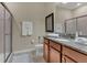 Bright bathroom featuring a granite countertop vanity, toilet, and glass-enclosed shower for a clean aesthetic at 8930 Azalea Sands Ln, Davenport, FL 33896