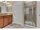 Well-lit bathroom featuring a walk-in shower, vanity with granite countertop, and modern fixtures at 8930 Azalea Sands Ln, Davenport, FL 33896