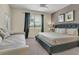 Inviting bedroom with king bed, daybed, plush pillows, and serene view for ultimate comfort and relaxation at 8930 Azalea Sands Ln, Davenport, FL 33896