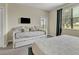 Bright bedroom with a daybed, king bed, TV, and sliding glass door offering natural light and outdoor access at 8930 Azalea Sands Ln, Davenport, FL 33896