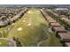 Expansive golf course surrounded by houses and mature trees at 8930 Azalea Sands Ln, Davenport, FL 33896