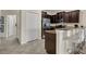 Modern kitchen featuring stainless steel appliances, dark cabinetry, counter seating, and access to the pantry at 8930 Azalea Sands Ln, Davenport, FL 33896