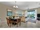 The living room features large windows and a dining table with seating for enhanced functionality at 8930 Azalea Sands Ln, Davenport, FL 33896