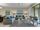 Bright living room with two sofas, two accent chairs, and a glass table for a cozy and inviting atmosphere at 8930 Azalea Sands Ln, Davenport, FL 33896