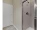 Modern bathroom shower featuring neutral tile, glass door, and updated fixtures for a refreshing experience at 8930 Azalea Sands Ln, Davenport, FL 33896
