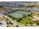 Aerial view of tennis courts surrounded by trees and lush green landscaping at 8930 Azalea Sands Ln, Davenport, FL 33896