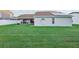 Large backyard showcasing a well-manicured lawn, a covered patio and a white fence at 1546 Thornhill Cir, Oviedo, FL 32765