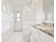 Bright bathroom featuring a marble countertop vanity, white cabinets, and a walk-in shower at 1546 Thornhill Cir, Oviedo, FL 32765