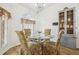 Breakfast nook featuring a glass table and floral patterned chairs, next to a cabinet at 1546 Thornhill Cir, Oviedo, FL 32765
