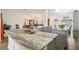 Open kitchen featuring granite countertops, stainless steel sink, and views of the living and dining areas at 1546 Thornhill Cir, Oviedo, FL 32765