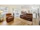 Comfortable living room with wood floors, leather seating, and sliding door access to the patio at 1546 Thornhill Cir, Oviedo, FL 32765