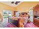Main bedroom with ceiling fan, en-suite bathroom access, and sliding glass door access to the yard at 1546 Thornhill Cir, Oviedo, FL 32765