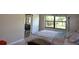 A cozy bedroom with a comfortable bed and a window overlooking a peaceful view at 3276 Candle Ridge Ct # 202, Orlando, FL 32822