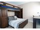 Comfortable bedroom with a bunk bed with a queen bed underneath, and a functional desk area at 3276 Candle Ridge Ct # 202, Orlando, FL 32822