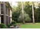Multi-story exterior view with lush landscaping, highlighting the community's serene and natural setting at 3276 Candle Ridge Ct # 202, Orlando, FL 32822