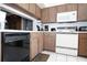 Functional kitchen with wood cabinets, white countertops, and modern appliances, providing plenty of counter space at 3276 Candle Ridge Ct # 202, Orlando, FL 32822