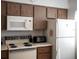 Bright kitchen with classic stove and oven, microwave, and refrigerator at 3276 Candle Ridge Ct # 202, Orlando, FL 32822