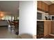 View from the kitchen, partially showing the kitchen cabinets and appliances, and beyond the dining and living rooms at 3276 Candle Ridge Ct # 202, Orlando, FL 32822