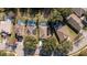 Aerial view of several homes with pools and solar panels in a residential neighborhood at 17512 Woodcrest Way, Clermont, FL 34714