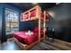 Unique bedroom featuring a rustic wooden bunk bed and dark accent wall at 17512 Woodcrest Way, Clermont, FL 34714