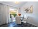 Cozy dining nook with white chairs next to a bright window and art at 17512 Woodcrest Way, Clermont, FL 34714