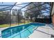 Inviting screened pool area with spa and well-maintained landscaping at 17512 Woodcrest Way, Clermont, FL 34714