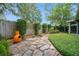 Backyard featuring a stone path, lush foliage, and an orange fire pit at 2657 Queen Mary Pl, Maitland, FL 32751