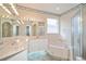 Bathroom with large mirrors, a bathtub and a shower stall at 2657 Queen Mary Pl, Maitland, FL 32751