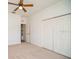 Spacious bedroom with a ceiling fan and a double door closet at 2657 Queen Mary Pl, Maitland, FL 32751