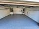 Spacious garage features clean, painted walls, updated epoxy flooring, and ample room for vehicles and storage at 2657 Queen Mary Pl, Maitland, FL 32751