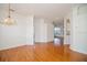 Open floor plan showcases hardwood floors, an elegant chandelier, and neutral wall paint at 2657 Queen Mary Pl, Maitland, FL 32751