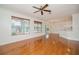 Bright living room with hardwood floors, ceiling fan, and large windows with blinds at 2657 Queen Mary Pl, Maitland, FL 32751