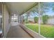View of a spacious screened-in patio overlooking the lush backyard at 2657 Queen Mary Pl, Maitland, FL 32751