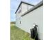 Side view showcasing light gray siding and a water softener system at 291 Whistling Duck Trl, St Cloud, FL 34771