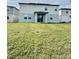 Two-story house with light gray siding and a large backyard at 291 Whistling Duck Trl, St Cloud, FL 34771