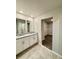 Bathroom with double sink vanity, granite counters and tiled floor, plus walk-in closet at 291 Whistling Duck Trl, St Cloud, FL 34771