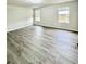 Bedroom with wood-look floors and two windows providing natural light at 291 Whistling Duck Trl, St Cloud, FL 34771