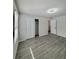 Bedroom with wood-look floors, closet, and natural light from window at 291 Whistling Duck Trl, St Cloud, FL 34771