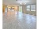 Open-concept living room featuring tile floors, modern chandelier and adjacent kitchen at 291 Whistling Duck Trl, St Cloud, FL 34771