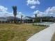 Landscaped lawn featuring pool, clubhouse, and shuffleboard and bocce ball courts for community enjoyment at 7358 Sw 76Th Ter, Ocala, FL 34481
