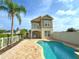 Charming home featuring a private pool, balcony, and lush landscaping at 7465 Excitement Dr, Reunion, FL 34747