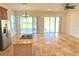 Open kitchen and living area with tile floors and sliding doors to patio at 7465 Excitement Dr, Reunion, FL 34747
