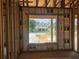 Framed window view of the home across the street, showcasing the neighborhood at 405 Long And Winding Rd, Howey In The Hills, FL 34737
