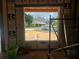 Framed window view of the home across the street, showcasing the neighborhood at 405 Long And Winding Rd, Howey In The Hills, FL 34737