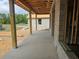 Exterior view under construction, showing block walls, support beams, and a concrete patio with potential at 405 Long And Winding Rd, Howey In The Hills, FL 34737